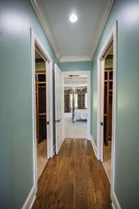 Two large custom primary walk in closets with pocket doors.