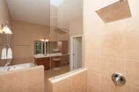 Luxurious walk-in tile shower with glass wall and rain head shower!