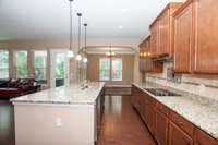 Tons of counter and cabinet space! Smooth cooktop, granite counters, tile backsplash, stainless appliances!