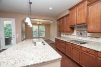 Tons of counter and cabinet space! Smooth cooktop, granite counters, tile backsplash, stainless appliances!