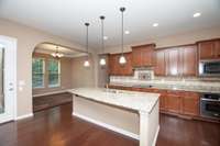 Dining room with lots of windows, and a beautiful arched doorway located right off of the kitchen.