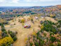 Features 2 barns, a lake, and small wet weather pond. 