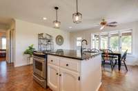 The kitchen connects to the family room and formal dining room.