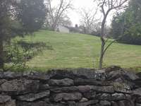 Picturesque drive to the house is flanked by old stacked stone walls.