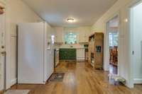 Another view of the kitchen from the breakfast area . Door on the left is to an exterior side porch.