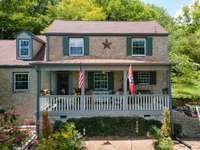 From the porch look over the lush open acreage and see the view of Brentwood in the distance.