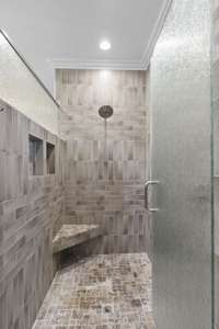 Double shower head walk in tiled shower in primary