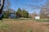 View of the rear of the home and the open backyard.