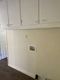 laundry area with cabinets