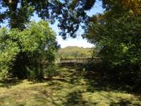 looking out in front of house and across the road into an open field