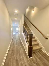 Entryway… laminate flooring throughout main level *Photo is from a completed unit with same grade finishes. Same layout.*