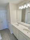 The primary bath has a double vanity with a large walk in shower.