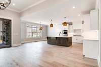 CUSTOM CABINETS WITH NICE CENTER ISLAND AND EATING AREA