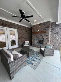 Great covered outdoor space with gas fireplace, tv connection and gas line for your outdoor kitchen! *previously built home, actual selections and finishes may vary