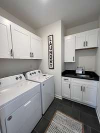 Landry room right off the Primary bedroom. *previously built home, actual selections and finishes may vary