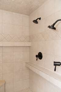 Doublehead shower with ledges built in for essentials as well as large corner seat