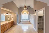 High ceilings in this bathroom and oversized window allows sunlight in and the grand feel for owner's to prepare for the day and unwind at night.  Soak in the tub or take a shower in the oversized seashell entry to wash off the day's stressors.