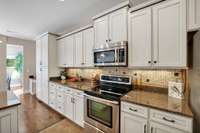 Beautiful Stainless Steel Appliances & Stagarged Cabinets with Roll Out Shelving  Galore! 