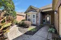 The Brick Pavers Encircle the Entire Home...You'll be Accompanied by Beautiful landscaping Along the Way. 