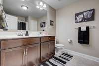 The guest bathroom includes an oversized single vanity, ample counter space, tile floors & ideal bathroom lighting! 1027 Waterstone Drive Lebanon, TN 37090