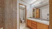 Hall bath has double vanity, and a jack and jill type set up with a door for the toilet and tub/shower.