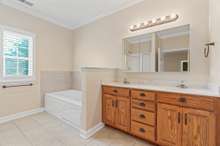 Master bath has double vanities and jetted soaking tub.