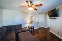 Another view of the living room showing the open area into the eat in kitchen.