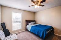 Another view of the Primary bedroom showing the window and ceiling fan. This bedroom has a double closet.