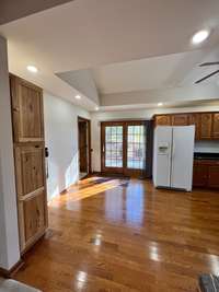 dinette area with custom wood patio doors leading to the back deck.  the door to the left is to the laundry, also has door up to next level of home. 