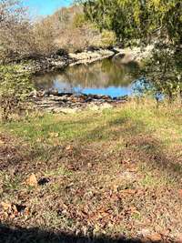 This is an area across from the bottom of the driveway where you can walk down to the water to fish or put a kayak or canoe in the water. 