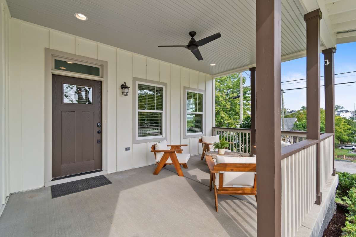 Adorable covered front porch with ceiling fan.