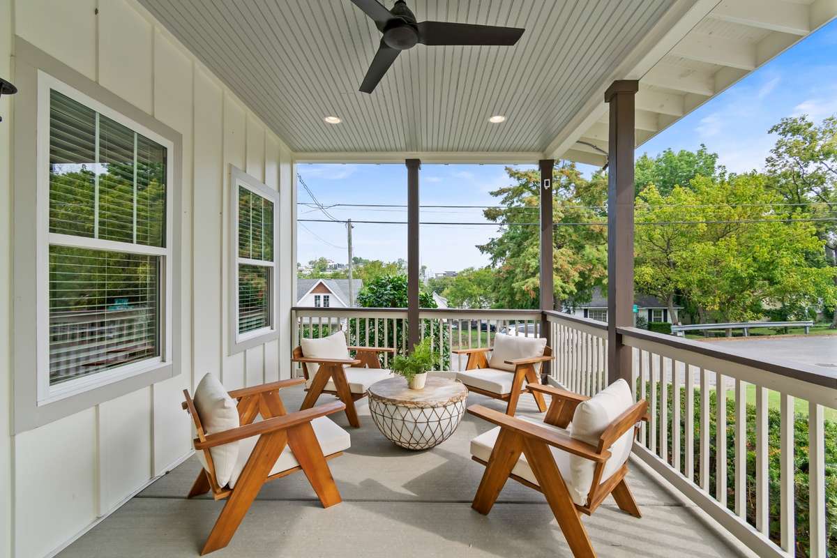Adorable covered front porch with ceiling fan.