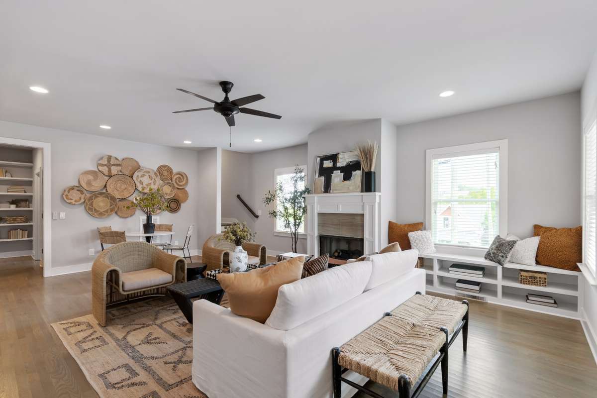 Spacious living room features a gas fireplace, built-in shelving, and tons of natural light. The hardwoods floors are beautiful!
