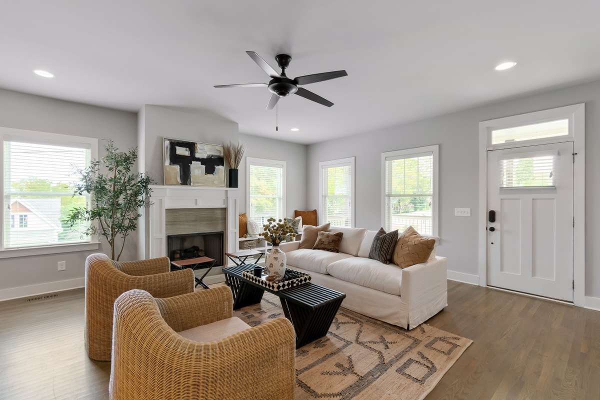 Spacious living room features a gas fireplace, built-in shelving, and tons of natural light. The hardwoods floors are beautiful!