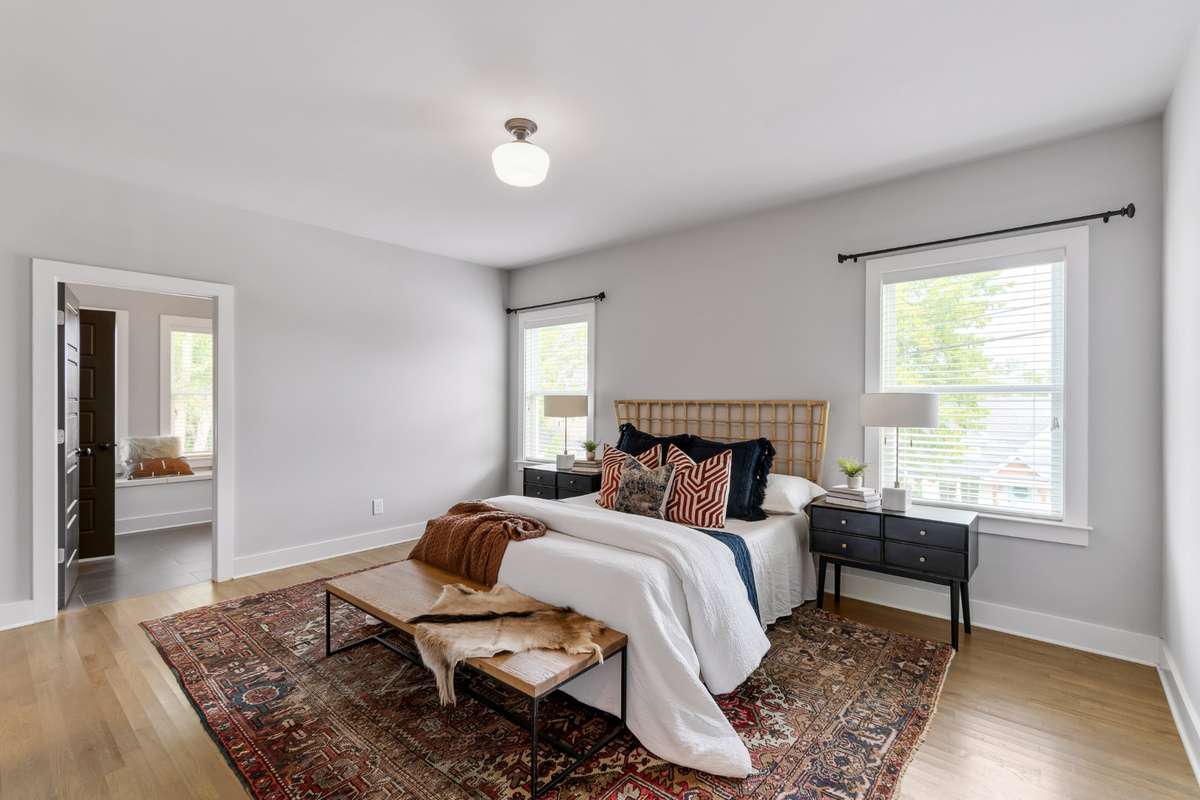 Large Primary Suite on Main Floor boasts gorgeous hardwood floors and a spacious walk-in closet and bath.