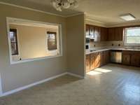 Kitchen and Dining Room showing the wall opening from the Dining Room into the Living Room.