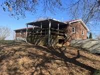 Another view showing the covered back porch with storage