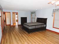Large primary bedroom with two walk in closets, built in bookshelves and on suite bathroom.