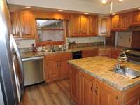 Stainless steel appliances remain with the home.  Center island offers additional storage and rinse sink.