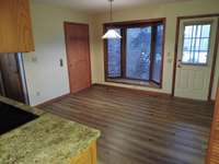 View of eat in kitchen with access to elevator, side exterior door, laundry room and garage.