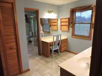The primary bathroom has dual vanities, dressing table, linen closet, separate walk in shower and tub.