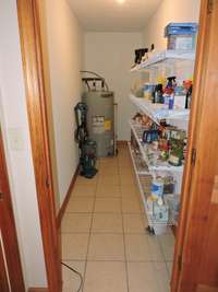 Pantry and newer water heater located in the in-law quarters.