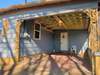 One car Carport leads into the Laundry Room, just off the Kitchen -- Concrete Drive