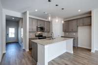 Spacious kitchen with a large granite island (very similar completed home)