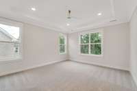 Large primary bedroom with trey ceiling and fan.  Choose between carpet or hardwood flooring in primary !