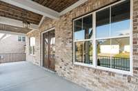 Beautiful covered front porch with tongue and groove ceiling.