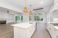 Just look at this dreamy kitchen! Custom cabinets w/ soft close drawers, gorgeous quarts tops, gas cooktop , double ovens, tiled back splash, our designer handpicked these beautiful pendant lights, dishwasher, microwave, walk in pantry and more!