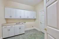 Nicely, appointed laundry room with dual entrances.