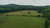 Additional, aerial shot of the back pasture and make note there is a water source available.