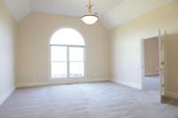 Large, secondary bedroom with vaulted ceiling.